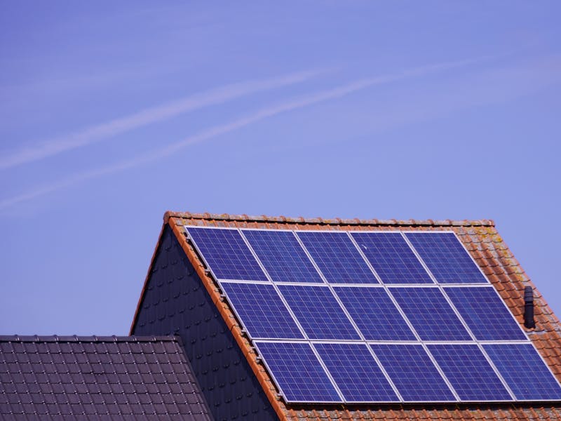 Solar panels mounted across a tiled house roof