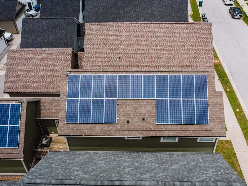 Aerial view of solar panels on neighbouring tiled roofs