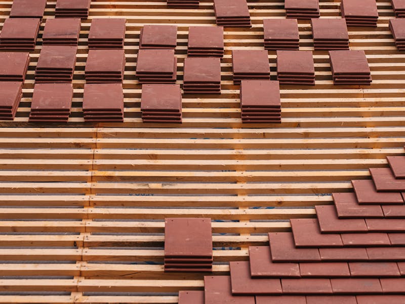 Roof tiles being laid on a house during a re-roof