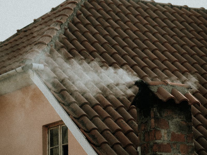 Semi-detached house with a newly tiled roof and brick chimney